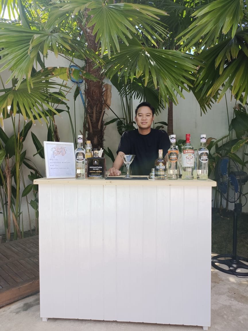 Professional bartender making cocktails at a Bali villa